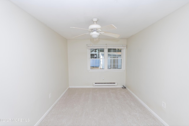 carpeted empty room featuring a baseboard heating unit and ceiling fan