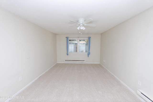 carpeted spare room with baseboard heating and ceiling fan