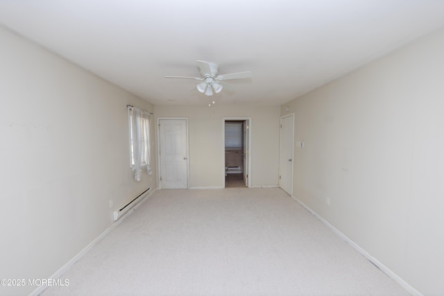 carpeted empty room featuring a baseboard radiator and ceiling fan