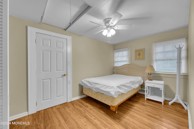 bedroom with ceiling fan and light hardwood / wood-style flooring