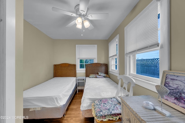 bedroom with wood-type flooring and ceiling fan