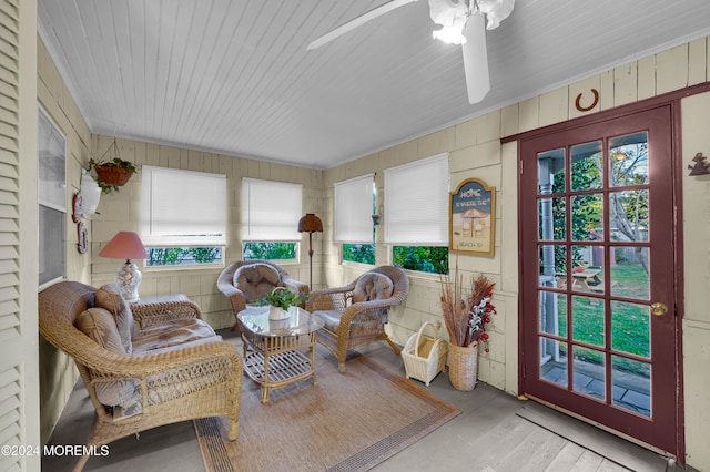 sunroom / solarium featuring ceiling fan