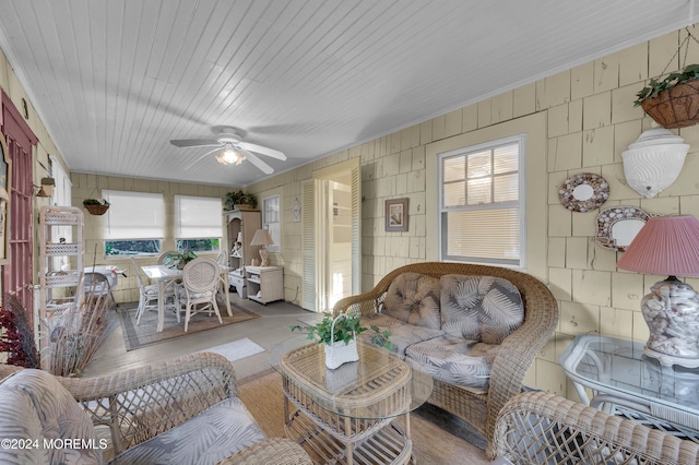 sunroom / solarium featuring ceiling fan