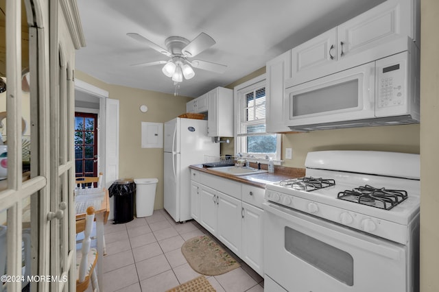 kitchen featuring sink, light tile patterned floors, white cabinets, white appliances, and ceiling fan