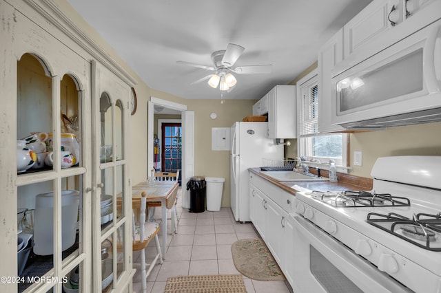 kitchen with white cabinets, ceiling fan, light tile patterned flooring, sink, and white appliances