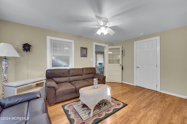 living room featuring light hardwood / wood-style flooring and ceiling fan