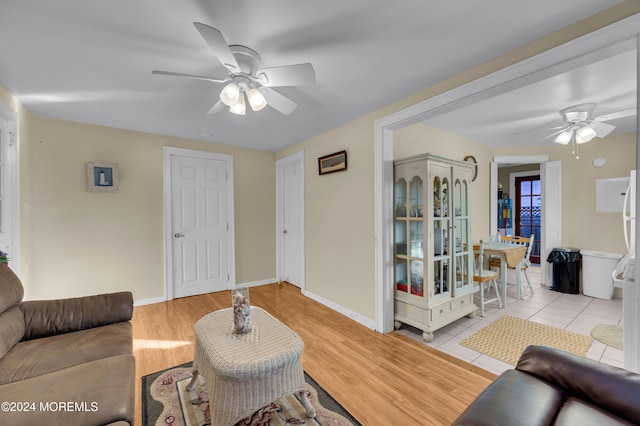 living room with light wood-type flooring and ceiling fan