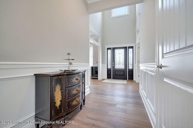 entrance foyer with a high ceiling and light wood-type flooring