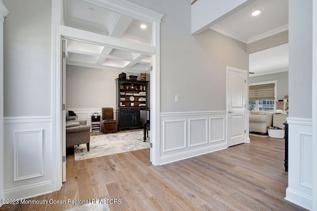 hallway featuring beamed ceiling, crown molding, coffered ceiling, and light hardwood / wood-style floors