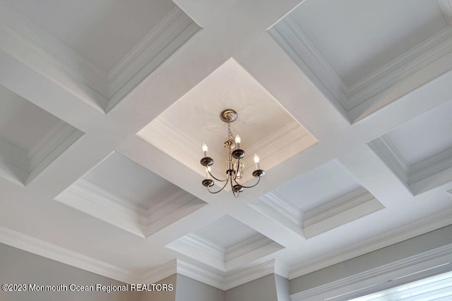 details with crown molding, coffered ceiling, and an inviting chandelier