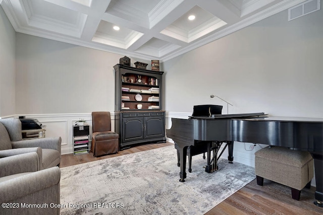 sitting room featuring coffered ceiling, ornamental molding, wood-type flooring, and beam ceiling