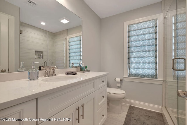 bathroom with vanity, toilet, and walk in shower