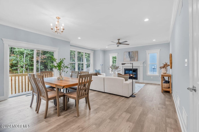 dining area featuring light hardwood / wood-style flooring, a healthy amount of sunlight, and crown molding