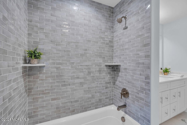 bathroom featuring vanity and tiled shower / bath combo