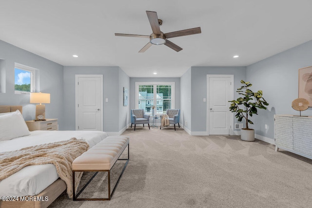 carpeted bedroom with multiple windows and ceiling fan