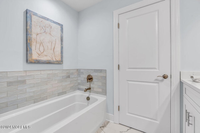 bathroom featuring vanity and a bath