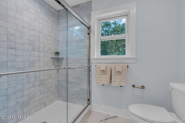 bathroom featuring toilet and walk in shower