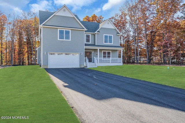 view of front of house featuring a front yard, covered porch, and a garage