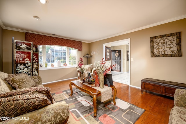 living room featuring crown molding and hardwood / wood-style flooring