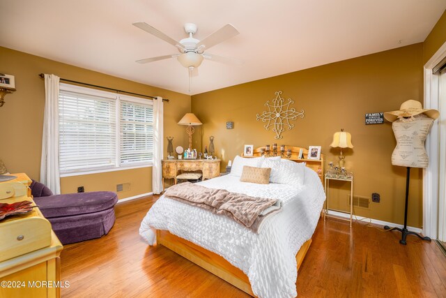 bedroom with ceiling fan and wood-type flooring