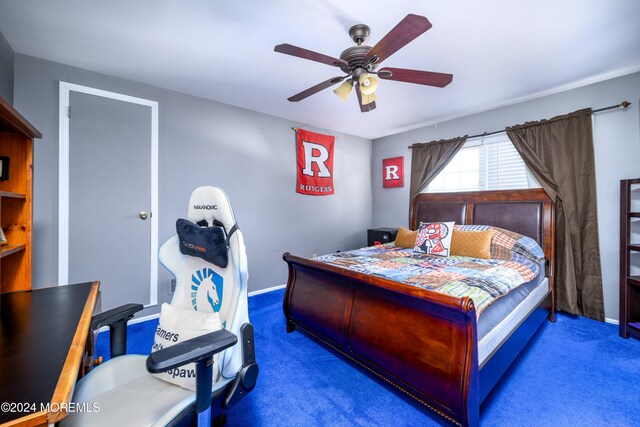 bedroom with dark carpet and ceiling fan