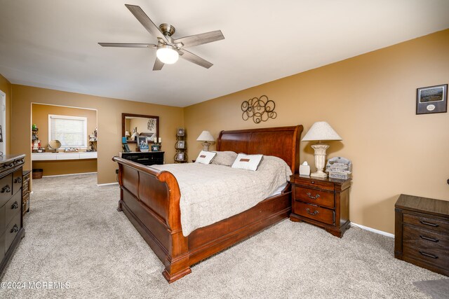 bedroom featuring light carpet and ceiling fan