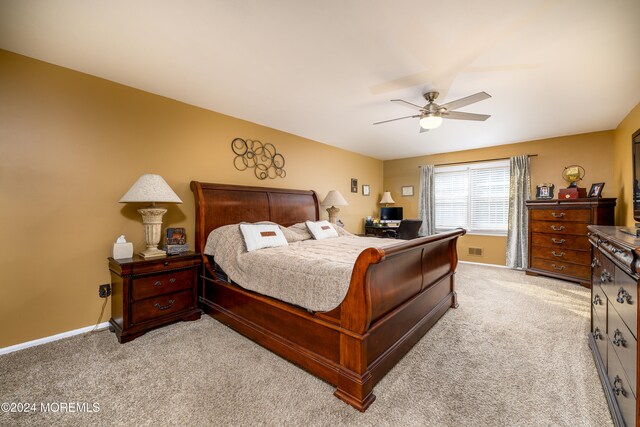 bedroom featuring light carpet and ceiling fan