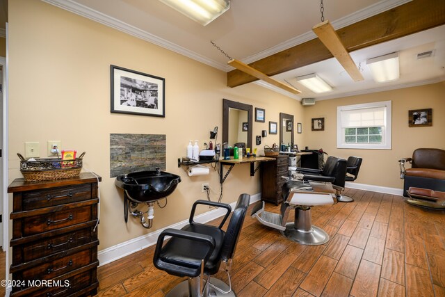 home office featuring beam ceiling, crown molding, and hardwood / wood-style flooring