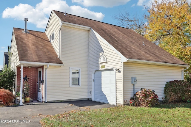 view of side of property with a lawn