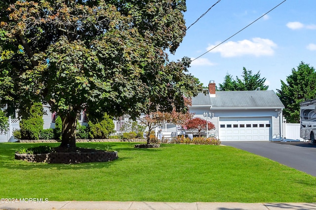 view of front of property with a front yard and a garage