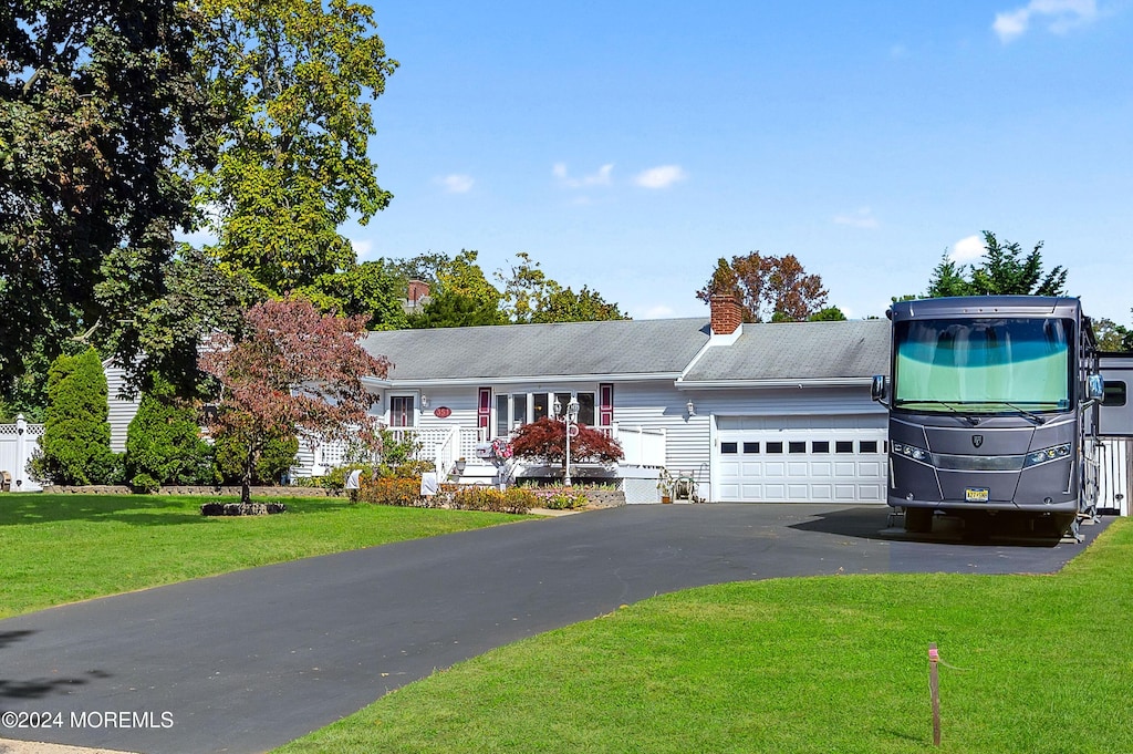 view of front of house with a garage and a front lawn