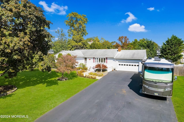 view of front of house with a front yard and a garage