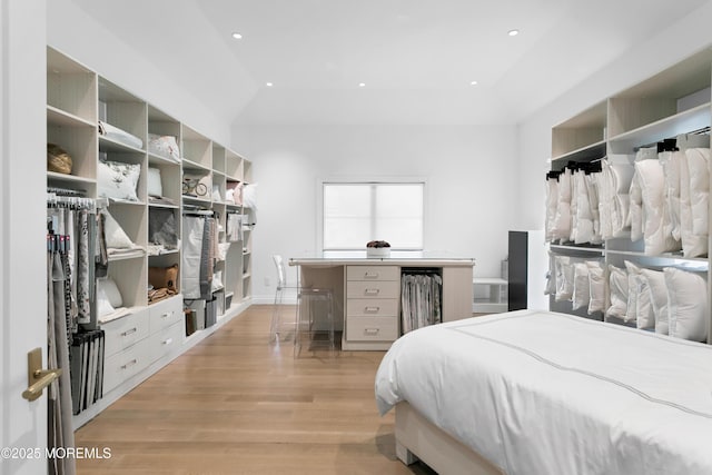 bedroom with light wood-type flooring and lofted ceiling