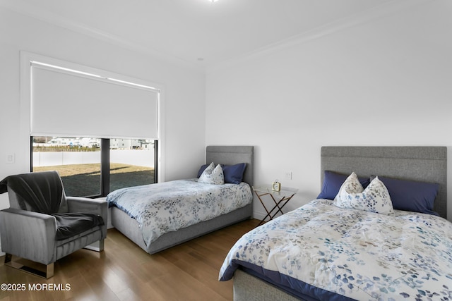 bedroom featuring hardwood / wood-style floors and crown molding