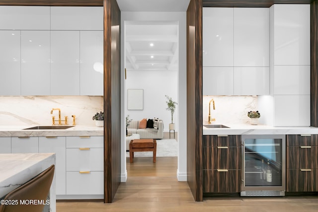 bar featuring white cabinets, decorative backsplash, beverage cooler, and coffered ceiling