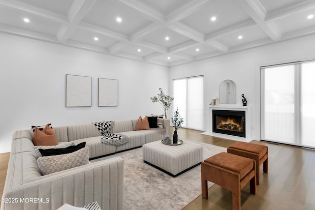 living room with beamed ceiling, coffered ceiling, and hardwood / wood-style flooring