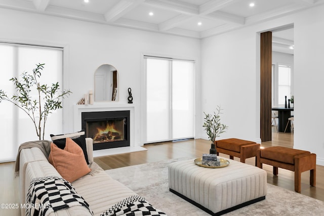 living room featuring beam ceiling, wood-type flooring, and coffered ceiling