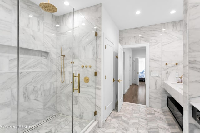 bathroom featuring vanity and a shower with door