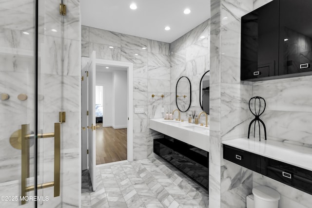 bathroom featuring vanity and tile walls