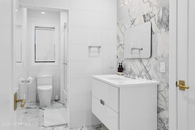 full bathroom with tile walls, vanity, shower / bathtub combination, and toilet