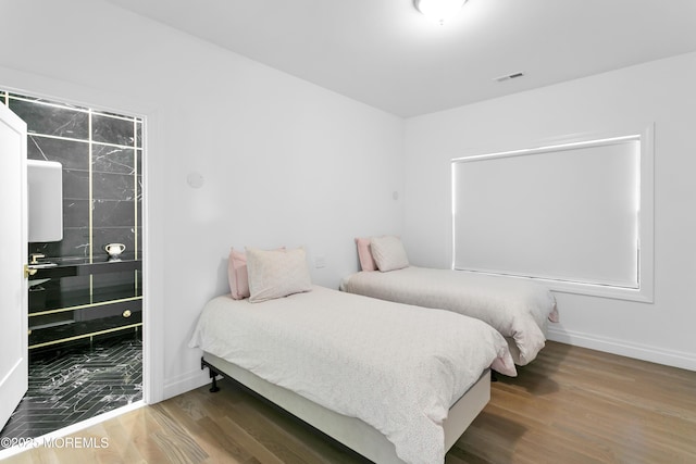 bedroom with hardwood / wood-style floors