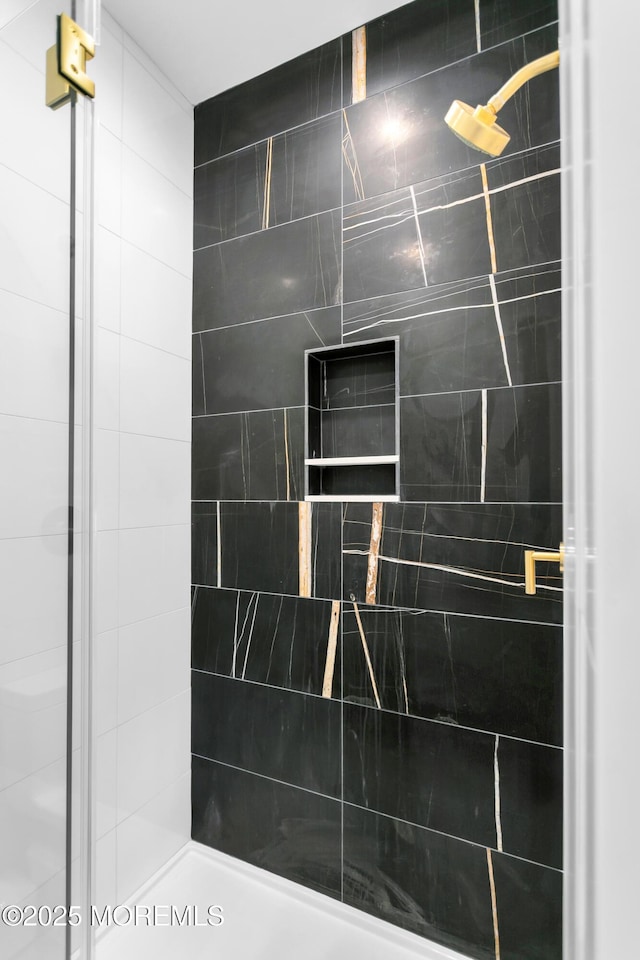 bathroom with a tile shower