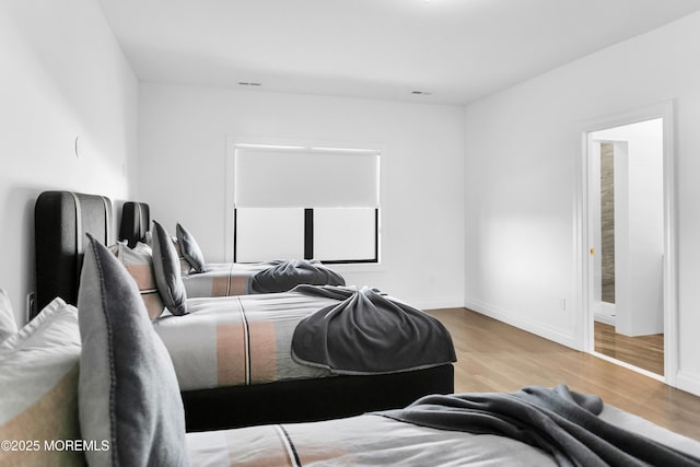 bedroom with light hardwood / wood-style floors