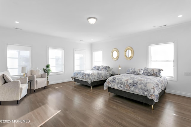 bedroom with crown molding and dark wood-type flooring