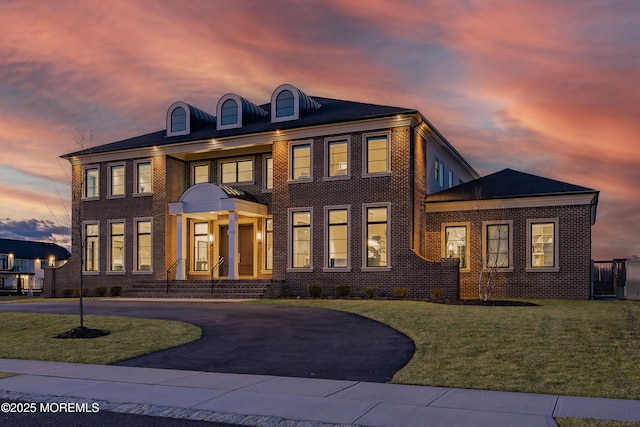 colonial-style house featuring a yard