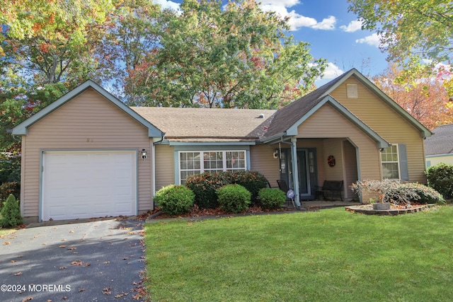 view of front of property with a garage and a front lawn