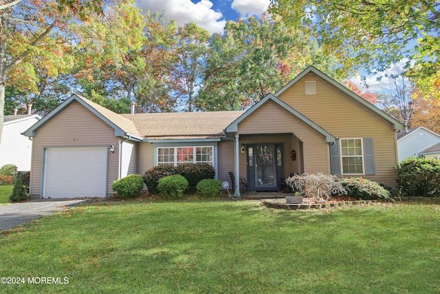 ranch-style house with a garage and a front lawn