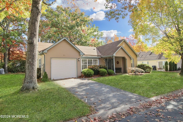 view of front of property with a front yard and a garage