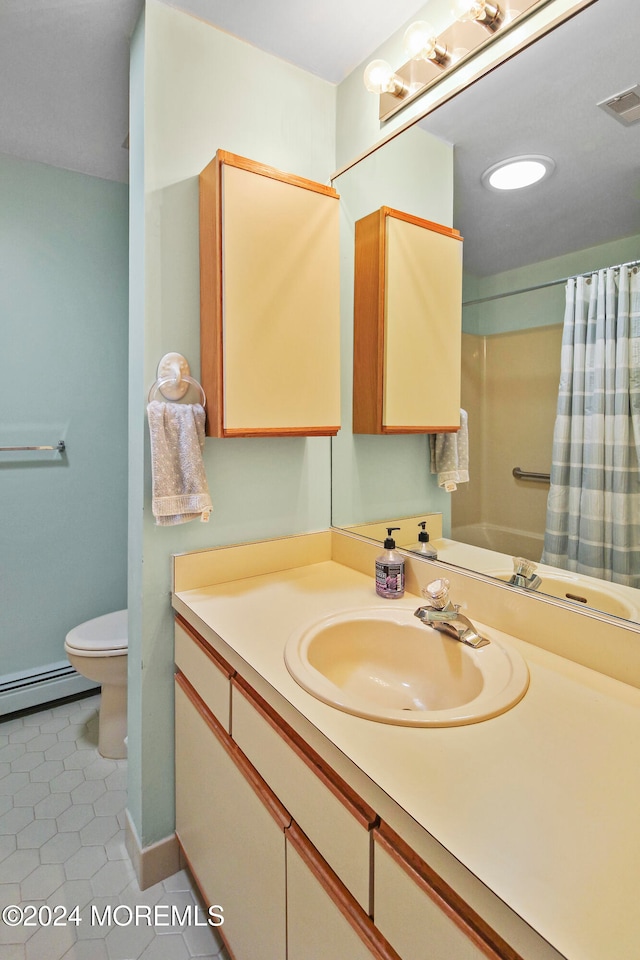 bathroom with vanity, toilet, tile patterned floors, and baseboard heating