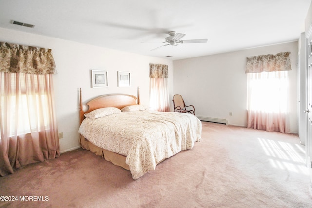 bedroom featuring carpet floors, a baseboard heating unit, and ceiling fan